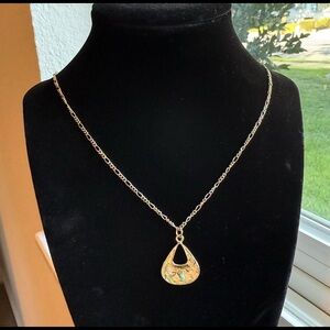 Handmade gold pendant necklace.